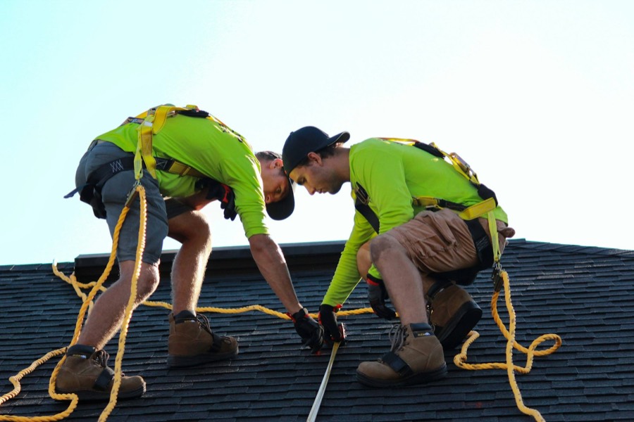 Roof replacement in Mooresville, NC: Reynolds Roofing crew installing shingles on a residential roof