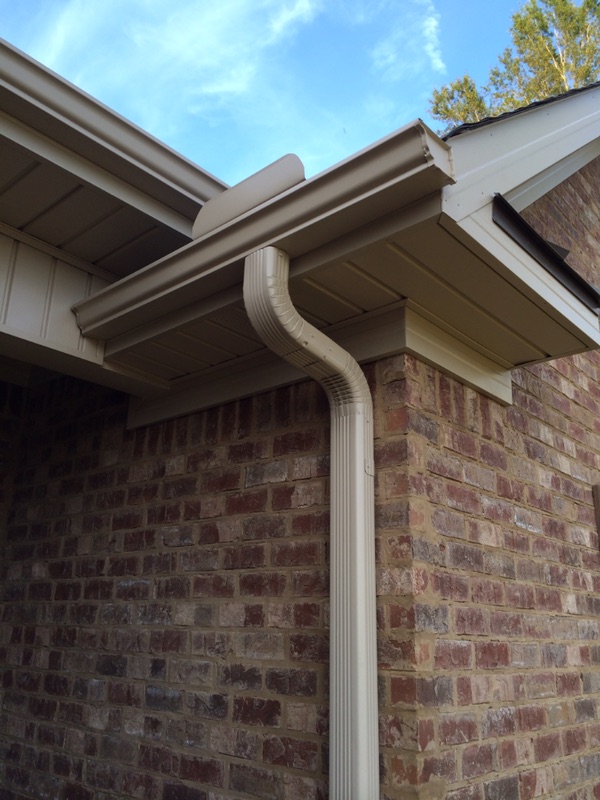 Seamless K-style aluminum gutter with a color-matched downspout installed by Reynolds Roofing on a brick home in Concord, NC