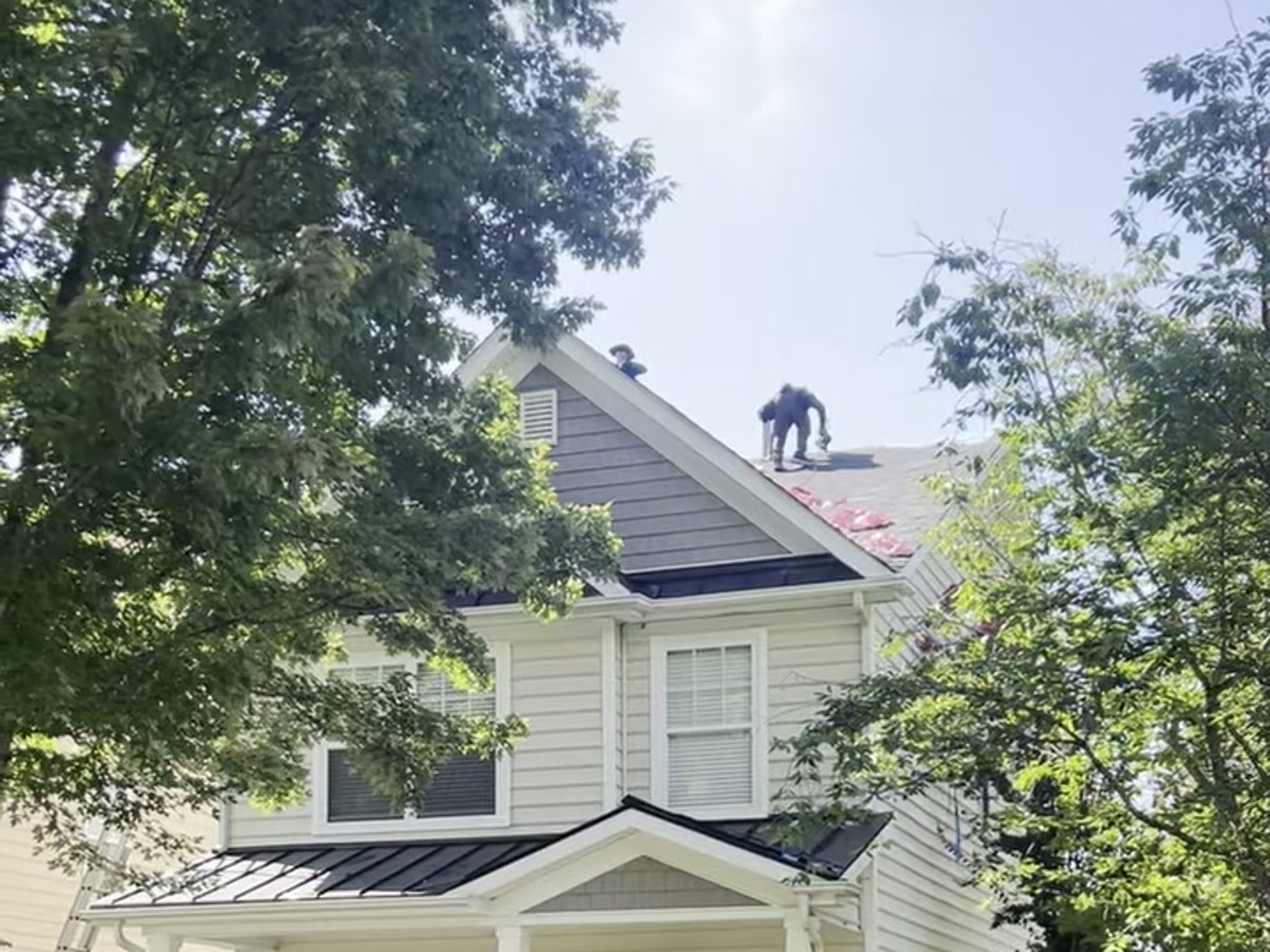 Reynolds Roofing crew replacing a roof on a two-story home in Huntersville, NC